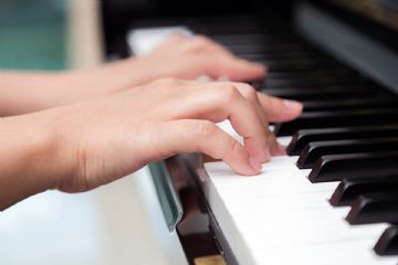 Foto di mani su tastiera del pianoforte